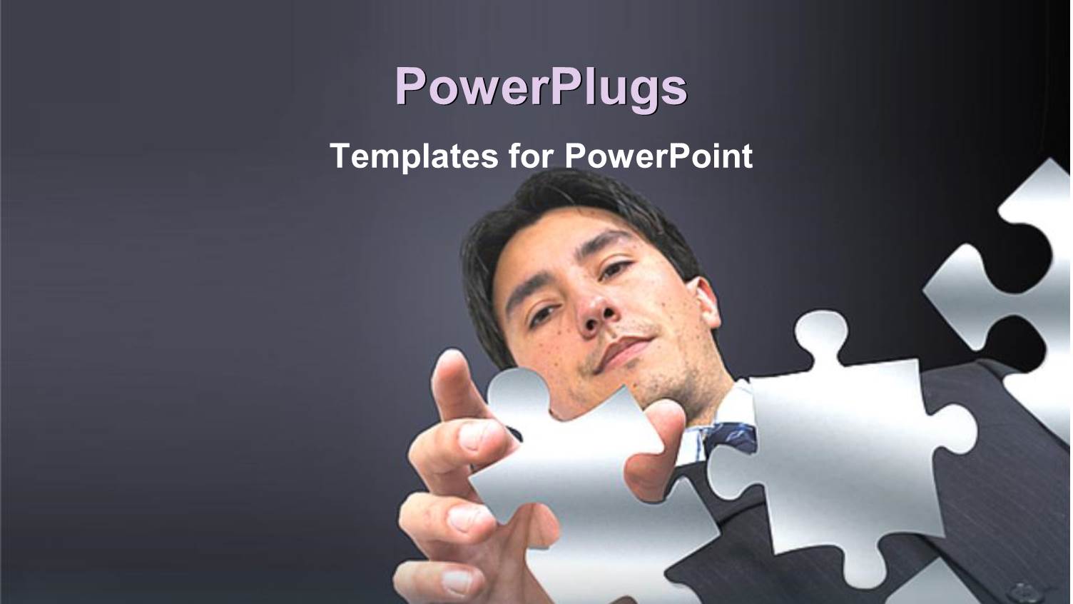 Young Man Putting Puzzle Pieces Together on Grey Background