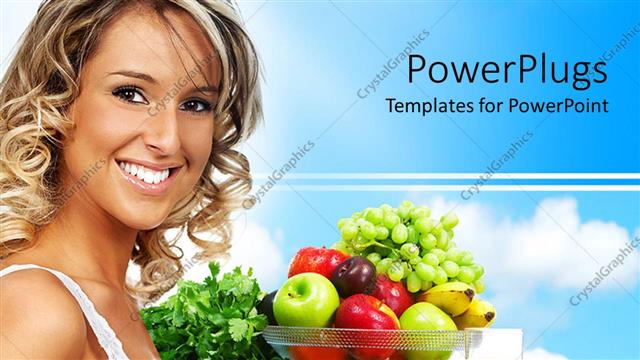  Presentation with healthy juice - Young blond smiling woman standing next to bowl with mix of fresh fruits and glass of juice, vegetables and fruits for healthy diet