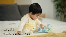  Presentation with doll - PPT theme consisting of adorable-hispanic-baby-playing background and a soft green colored foreground