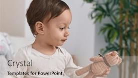  Presentation with doll - Presentation theme having adorable-hispanic-boy-sitting background and a soft green colored foreground