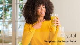  Presentation with healthy juice - PPT theme consisting of african american woman drinking healthy fruit juice at home very happy pointing with hand and finger background and a yellow colored foreground
