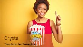  Presentation with african american woman question - Cool new presentation design with african american woman holding pack of popcorn over yellow isolated background surprised with an idea or question pointing finger with happy face number one backdrop and a gold colored foreground
