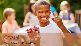  Presentation with rich - PPT layouts consisting of african boy eats rich in vitamins cherries laughing with joy background and a coral colored foreground