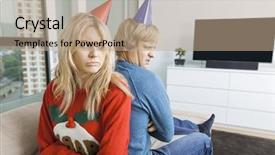  Presentation with christmas party - PPT theme enhanced with annoyed couple in christmas sweaters and party hats sitting back to back at home background and a coral colored foreground