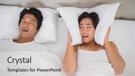  Presentation with snoring - Presentation consisting of annoyed woman covering her ears with pillows to block out snoring at home in bedroom background and a soft green colored foreground