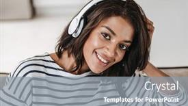 Presentation with american music - PPT theme consisting of attractive young afro american woman sitting on a couch at home listening to music with headphones background and a gray colored foreground