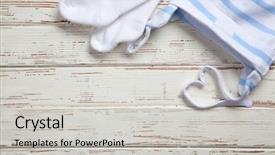  Presentation with baby clothes - Amazing PPT theme having baby clothes on wooden background backdrop and a light gray colored foreground