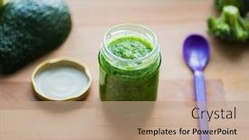  Presentation with baby food jar - Theme consisting of baby food healthy eating and nutrition concept - glass jar with green vegetable puree on wooden cutting board background and a coral colored foreground