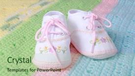  Presentation with baby shoes - Amazing PPT theme having baby girl shoes backdrop and a mint green colored foreground