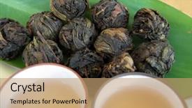  Presentation with brewed - Presentation consisting of balls of high quality dried chinese tea leaves cups of freshly brewed chinese tea ready for drinking background and a coral colored foreground