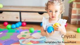  Presentation with infant - Colorful presentation enhanced with beautiful caucasian infant playing with toys at colorful playroom happy and playful wth colorful balls at kindergarten backdrop and a coral colored foreground