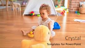  Presentation with infant - PPT theme enhanced with beautiful caucasian infant playing with toys at colorful playroom happy and playful cuddling stuffed animal at kindergarten background and a yellow colored foreground