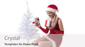  Presentation with christmas girl - PPT theme consisting of beautiful girl with a gift in a santa's cap sits near a christmas tree on a white background background and a light gray colored foreground