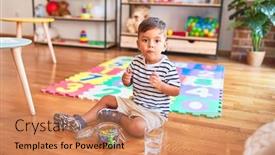  Presentation with toddler eating - Presentation design with beautiful toddler boy sitting on puzzle eating small colored chocolate balls at kindergarten background and a coral colored foreground