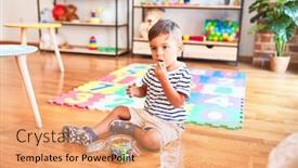  Presentation with toddler eating - Presentation enhanced with beautiful toddler boy sitting on puzzle eating small colored chocolate balls at kindergarten background and a coral colored foreground