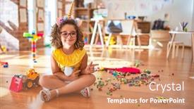  Presentation with unicorn - Presentation theme consisting of beautiful toddler wearing glasses and unicorn diadem sitting on the floor at kindergarten smiling and looking at the camera pointing with two hands and fingers to the side background and a coral colored foreground
