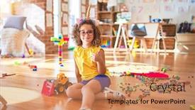  Presentation with unicorn - Cool new presentation theme with beautiful toddler wearing glasses and unicorn diadem sitting on the floor at kindergarten doing happy thumbs up gesture with hand approving expression looking at the camera with showing success backdrop and a coral colored foreground