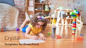  Presentation with unicorn - PPT theme featuring beautiful toddler wearing glasses and unicorn diadem lying down on the floor drawing using paper and pencil at kindergarten background and a coral colored foreground