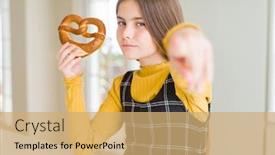  Presentation with salty - Colorful slide set enhanced with beautiful young girl kid eating german snack salty pretzel pointing with finger to the camera and to you hand sign positive and confident gesture from the front backdrop and a coral colored foreground