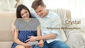  Presentation with ultrasound - Cool new PPT theme with beautiful young pregnant couple looking at ultrasound image while sitting on sofa backdrop and a soft green colored foreground