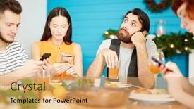  Presentation with dinner - PPT theme consisting of bored guy with glass of juice sitting by served dinner table among his friends searching in their gadgets background and a yellow colored foreground