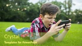  Presentation with gadget - Colorful PPT theme enhanced with boy lying on the grass and using modern gadget young gamer in the park backdrop and a tawny brown colored foreground
