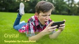  Presentation with gadget - PPT theme featuring boy lying on the grass and using modern gadget young gamer in the park background and a tawny brown colored foreground