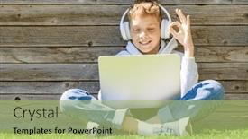  Presentation with entertainment - Presentation theme having boy-using-a-laptop background and a mint green colored foreground