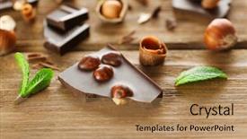  Presentation with hazelnuts - Colorful slides enhanced with broken black chocolate with hazelnuts and fresh mint on wooden table backdrop and a coral colored foreground