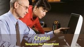  Presentation with monitor computer - PPT theme having businessman and businesswoman in office looking and pointing at computer monitor background and a tawny brown colored foreground