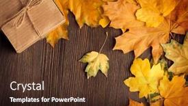  Presentation with autumn leaves - Presentation theme consisting of cardboard box tied with string on a bow on a wooden background in autumn leaves holiday gift on thanksgiving hellouin view from the top copy space background and a tawny brown colored foreground