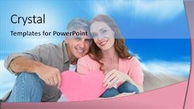  Presentation with pink sky - Theme consisting of casual couple holding pink heart against large rock overlooking blue sky background and a light blue colored foreground
