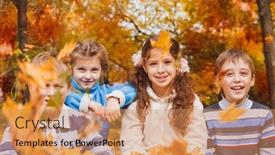  Presentation with school kids - PPT theme having cheerful group of kids of school age playing with yellow leaves in an autumn park background and a coral colored foreground