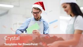  Presentation with packaging - Amazing slides having cheerful positive young man in santa hat wearing apron and eyeglasses standing at table and putting christmas card in red paper bag while packaging holiday gifts in workshop backdrop and a coral colored foreground