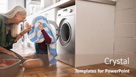  Presentation with clothes washing machine - Presentation having child hiding in blue and striped towel scaring mature woman near washing machine at home playing with fresh laundry clothes on floor grandchild plays the ghost with her head covered by a towel background and a coral colored foreground