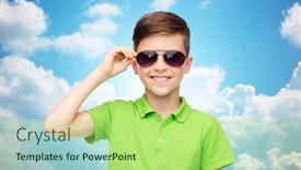  Presentation with green fashion - Amazing presentation theme having childhood fashion accessory style and people concept - happy smiling boy in sunglasses and green polo t-shirt over blue sky and clouds background backdrop and a mint green colored foreground