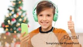  Presentation with christmas music - Cool new theme with children technology and people concept - smiling boy with smartphone and headphones listening to music at home over christmas tree background showing thumbs up backdrop and a coral colored foreground
