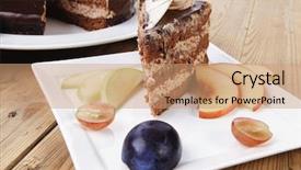  Presentation with table grape - Audience pleasing PPT layouts consisting of chocolate cream brownie cake layers slice topped with white chocolate and cream flowers decorated with fruits apple plum and grape on plate on wooden table with big whole cake backdrop and a coral colored foreground