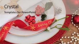  Presentation with holly - Theme enhanced with christmas dinner place setting with plates napkin ribbon holly and mistletoe with red baubles over oak background background and a soft green colored foreground