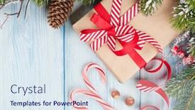  Presentation with fir tree - Colorful presentation theme enhanced with christmas gift box and fir tree branch on wooden table top view with copy space backdrop and a sky blue colored foreground