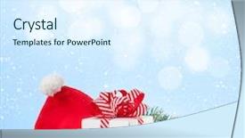  Presentation with fir tree - Presentation enhanced with christmas gift box santa hat and fir tree branch on wooden table with background for copy space background and a sky blue colored foreground