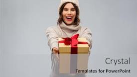  Presentation with young happy people smiling - Colorful slide set enhanced with christmas holidays and people concept - happy smiling young woman in knitted winter hat and sweater holding gift box over grey background backdrop and a light gray colored foreground