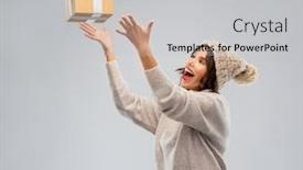  Presentation with young happy people smiling - Presentation design featuring christmas holidays and people concept - happy smiling young woman in knitted winter hat and sweater catching gift box over grey background background and a light gray colored foreground