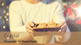  Presentation with christmas baking - Colorful theme enhanced with christmas holidays baking people and food concept - close up of woman with oat cookies sitting at wooden table at home backdrop and a yellow colored foreground