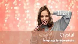  Presentation with ugly christmas sweater - Presentation consisting of christmas people and holidays concept - happy young woman wearing ugly sweater with reindeer pattern biting candy cane over festive lights on pink coral background background and a coral colored foreground