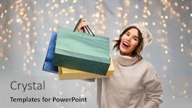  Presentation with christmas sale - Presentation theme enhanced with christmas seasonal sale and consumerism concept - happy smiling young woman in knitted winter hat and sweater with shopping bags over festive lights on grey background background and a coral colored foreground