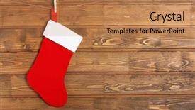  Presentation with christmas stocking - PPT theme consisting of christmas stocking hanging against wooden wall background and a coral colored foreground