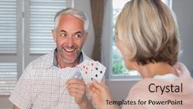  Presentation with playing cards - Colorful presentation theme enhanced with close-up of a happy mature man playing cards with woman at home backdrop and a coral colored foreground