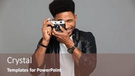  Presentation with objective - Beautiful PPT theme featuring close-up photo of young cheerful african man looking through retro cameras objective while taking photo isolated on gray background backdrop and a tawny brown colored foreground