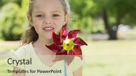  Presentation with pinwheel - Cool new presentation theme with close-up portrait of cute girl holding pinwheel at the park backdrop and a soft green colored foreground